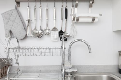 a kitchen rack with utensils hanging on a wall at amazing apartments - Annandale St near The Playhouse - Free Parking in Edinburgh