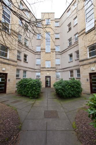 a large brick building with a door in a courtyard at amazing apartments - Annandale St near The Playhouse - Free Parking in Edinburgh