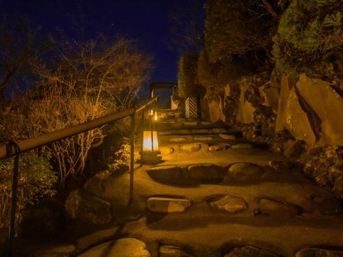 a stone path at night with a light on it at Nagominoyado Hanagokoro - Reopening in Mar 2024 in Hakone
