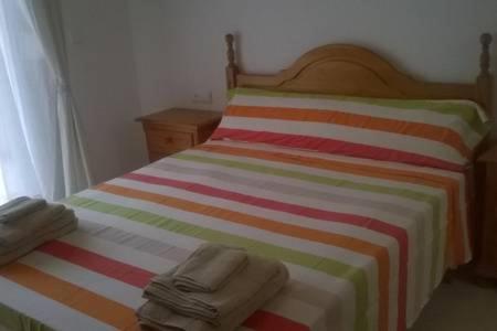 a bedroom with a bed with two towels on it at Casa Andalusí Carboneras in Carboneras