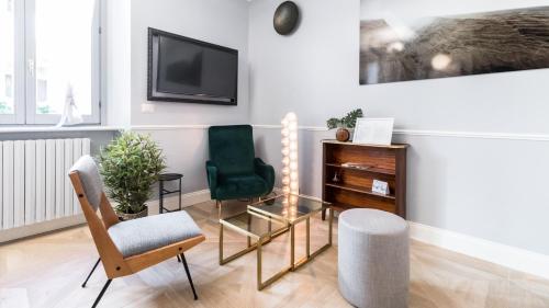 米蘭的住宿－Italianway - Garigliano 4 Flat，客厅配有两把椅子和电视