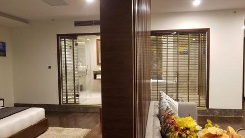 a bedroom with a bed and a couch in a room at Eagle Hotel in Ha Tinh