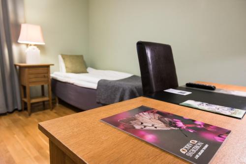 Una habitación con una mesa con una revista. en Nordens Ark Hotell, en Stranderäng