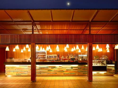 a restaurant with a bar with lights above it at Hapimag Resort Cefalù in Cefalù