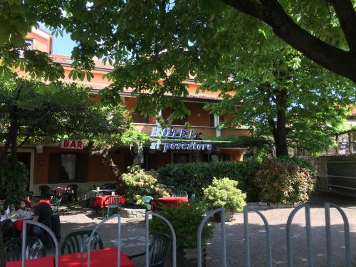 a restaurant with tables and chairs in front of a building at Hotel Al Pescatore in Duino