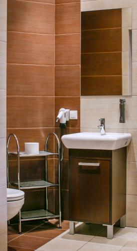 a bathroom with a sink and a toilet at Boutique Hotel's II Rewolucji in Łódź