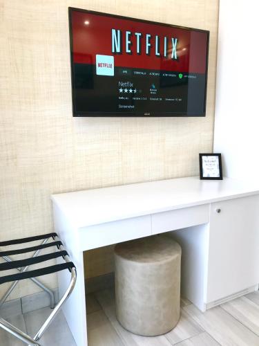 a white desk with a television on a wall at BRAKKO 45 in Naples