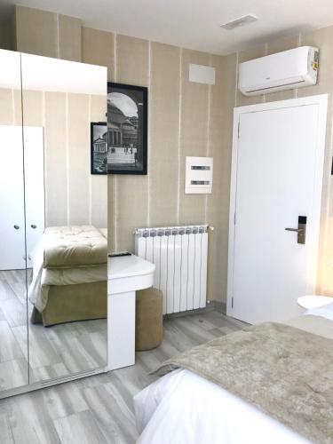 a bedroom with a bed and a sink and a mirror at BRAKKO 45 in Naples