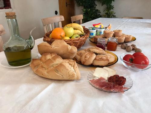 een tafel met brood en fruit en een fles wijn bij La Hermandad de Villalba in Villalba de los Barros