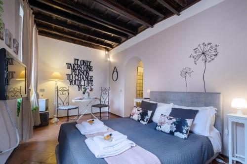 a bedroom with a bed with towels on it at Rome As You Feel - Santo Stefano in Rome