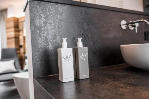 two bottles ofodorizers sitting on a counter in a bathroom at matill - timeless boutique retreat in Laces