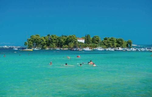 a group of people swimming in a large body of water at Villa Vesna in Preko