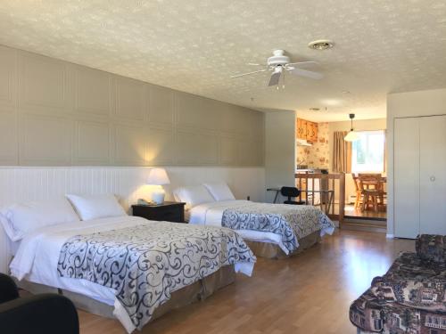 ein Hotelzimmer mit 2 Betten und einem Deckenventilator in der Unterkunft Motel le Sabre in Sherbrooke