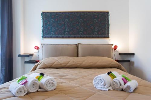 a bedroom with a bed with folded towels on it at My Way - Suite - Rooms - Palazzo San Matteo in Palermo