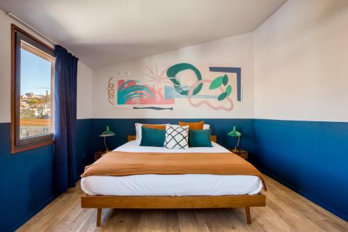 a bedroom with a large bed with blue walls at Secret Patio Lisbon in Lisbon