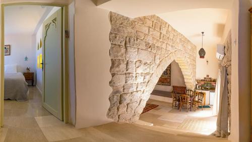 a hallway with a stone wall in a house at The Way Inn - Boutique Suites in Safed
