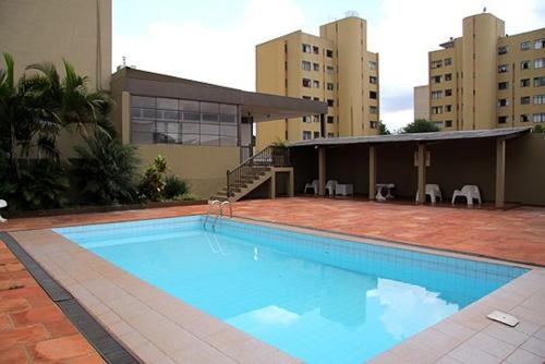 a large swimming pool in front of a building at Apucarana Palace Hotel in Apucarana
