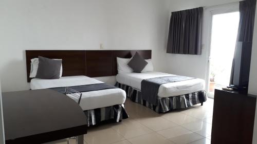 Säng eller sängar i ett rum på Hotel Arbol de Sueños