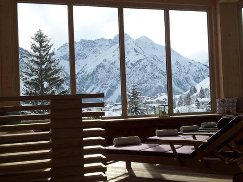 a room with a view of a snowy mountain at Haller's Geniesserhotel in Mittelberg