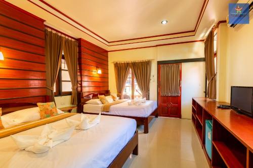 Un pat sau paturi într-o cameră la Starlight Haadrin Resort