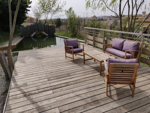 two chairs and a table on a wooden deck at Les Terrasses de Valensole in Valensole