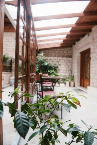 a patio with a table and chairs and a plant at Kentrikon in Ioannina