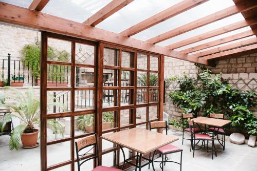 a patio with tables and chairs and windows at Kentrikon in Ioannina