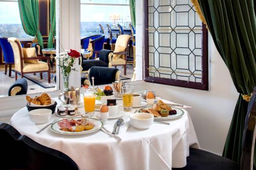 a table with plates of food and drinks on it at Chateau Le Prieuré Saumur - La Maison Younan in Chènehutte-les-Tuffeaux