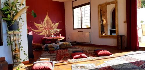 a living room with red walls and a large mirror at Ashram Villa Sunshine in Sitges