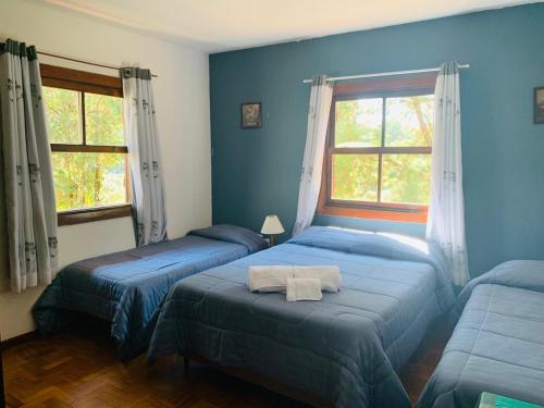 En eller flere senge i et værelse på Hotel Refúgio Alpino