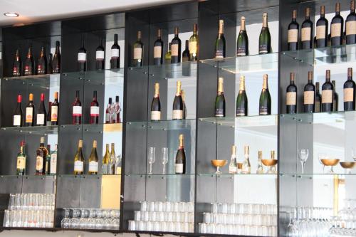 a display case filled with bottles and glasses of wine at Grand Hotel Jonkoping, BW Signature Collection in Jönköping