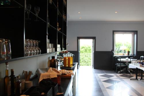 a restaurant with a counter and a table with chairs at Grand Hotel Jonkoping, BW Signature Collection in Jönköping