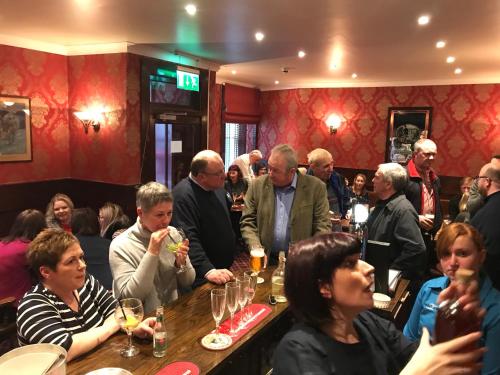 a large group of people sitting around a bar at Selkirk Arms Hotel in Kirkcudbright