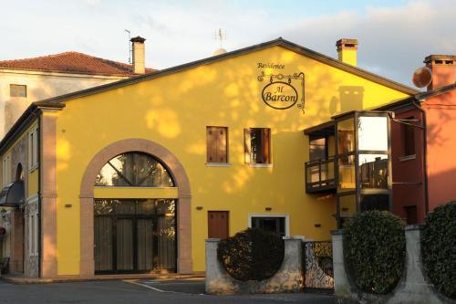 a yellow building with a sign on it at Residence Al Barcon in Sarcedo