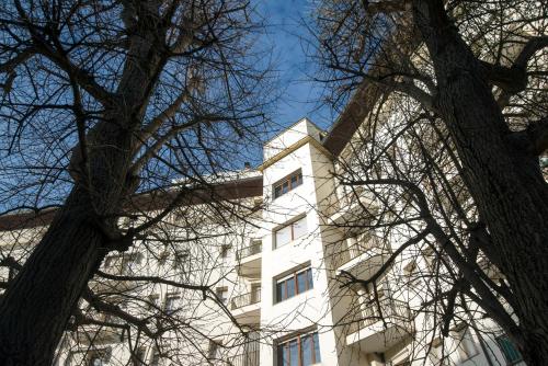 a tall white building with trees in front of it at Casa Al Carmine in Padova