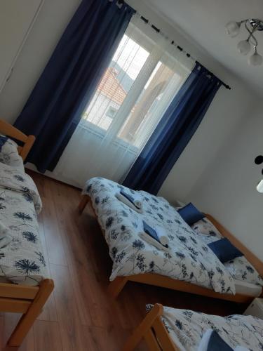 a bedroom with two beds and a window at Nijona 1 in Trebinje