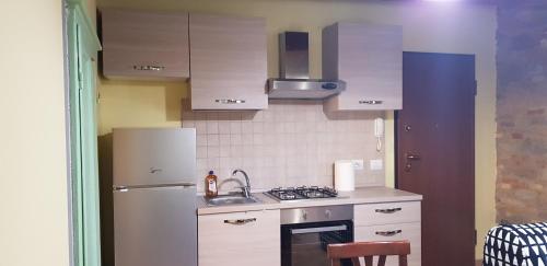 a small kitchen with a sink and a refrigerator at Defi house in Chianni
