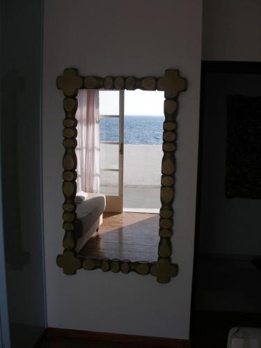 a mirror in a room with a view of the ocean at Beach Villa Akrotiri in Engares
