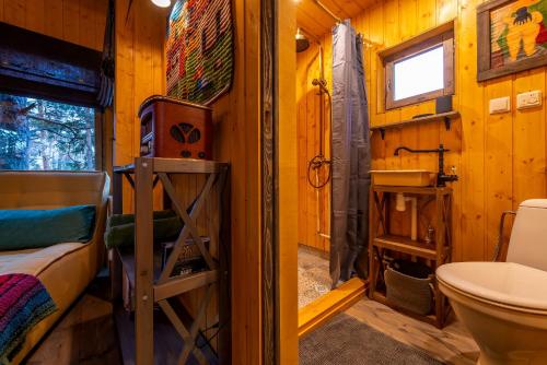 a small bathroom with a toilet and a sink at Sambliku Treehouse in Jõgisoo
