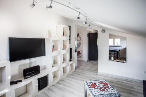 a living room with a flat screen tv on a wall at La Casetta di Sù in Maracalagonis
