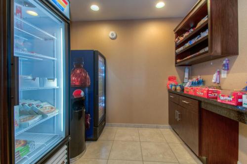 a refrigerator with its door open in a kitchen at Cobblestone Inn & Suites - Wray in Wray