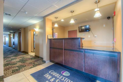 a corridor of a hospital lobby with a reception desk at Cobblestone Inn & Suites - Wray in Wray