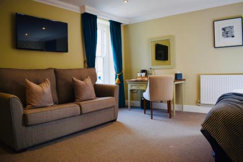 a living room with a couch and a desk at The Devonport in Darlington