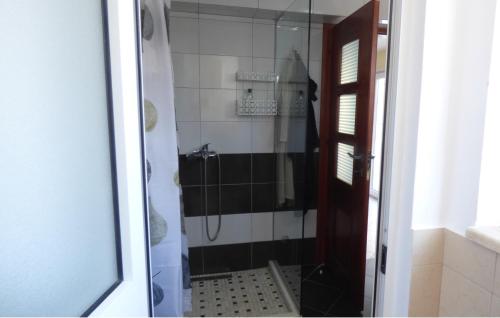 a bathroom with a shower with a glass door at Duplex in Durrës