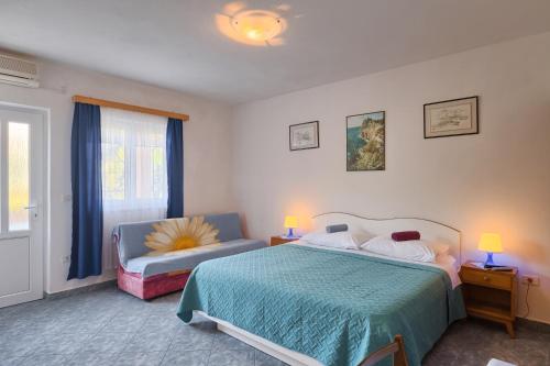 a bedroom with a bed and a chair in it at Vila Milla in Premantura