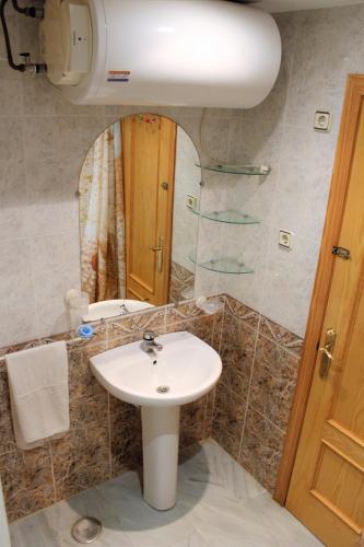 a bathroom with a sink and a mirror at PUERTA DEL MAR in Almuñécar