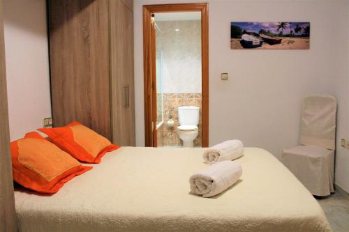- une chambre avec un lit et des serviettes dans l'établissement PUERTA DEL MAR, à Almuñécar