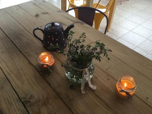 a wooden table with a tea pot and lights on it at Hotel Kelman in Perito Moreno