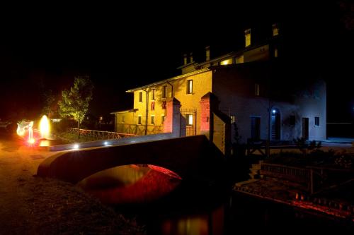 a house and a bridge at night with a building at Country House Casco Dell'Acqua in Trevi