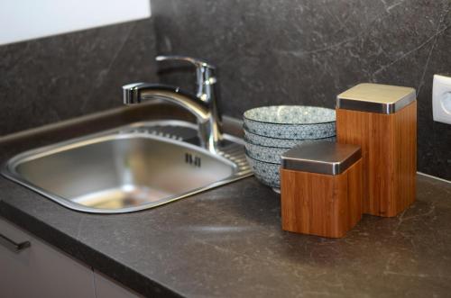 a kitchen sink with a faucet and a bowl at Apartment Zimat in Chienes